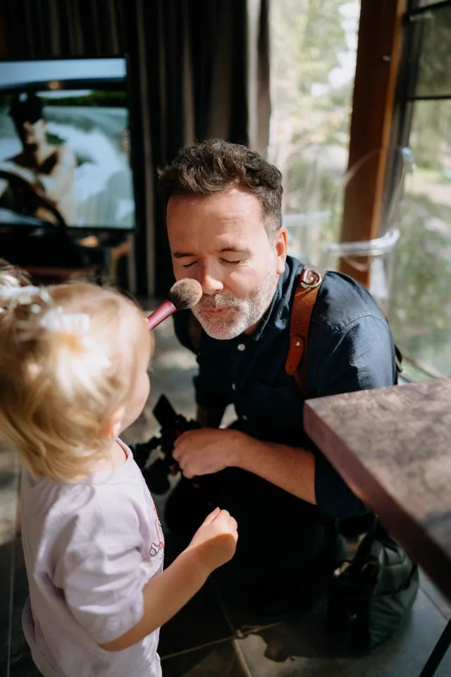 Gareth's little girl dusting his nose with a makeup brush